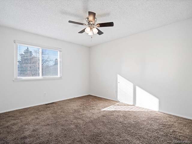 spare room with carpet floors, a textured ceiling, and ceiling fan