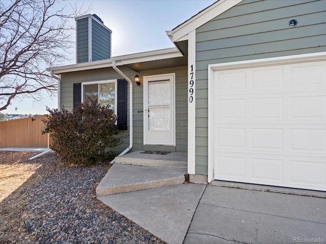 view of exterior entry with a garage