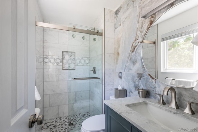 5983 W Indore Pl, Littleton, CO 80128 - full bath with vanity, a shower stall, and tile walls