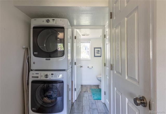 5983 W Indore Pl, Littleton, CO 80128 - laundry room featuring estacked washer and dryer and wood finish floors