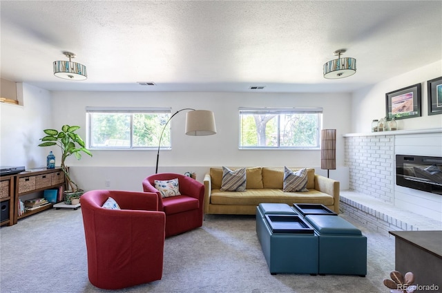 5983 W Indore Pl, Littleton, CO 80128 - carpeted living area featuring plenty of natural light, a fireplace, and a textured ceiling