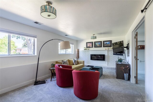 5983 W Indore Pl, Littleton, CO 80128 - carpeted living area with a fireplace and baseboards