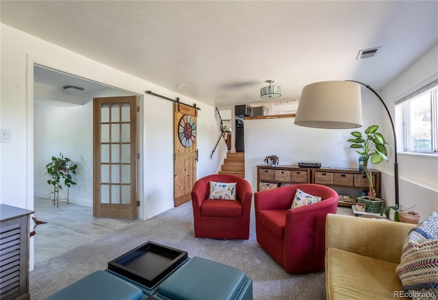 5983 W Indore Pl, Littleton, CO 80128 - carpeted living room with a barn door and stairs