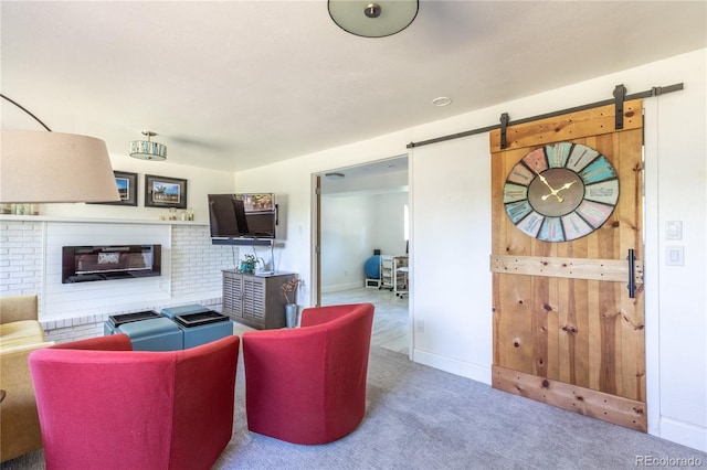 5983 W Indore Pl, Littleton, CO 80128 - living room featuring a barn door, carpet, and a brick fireplace