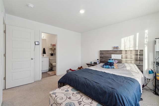 carpeted bedroom with ensuite bath