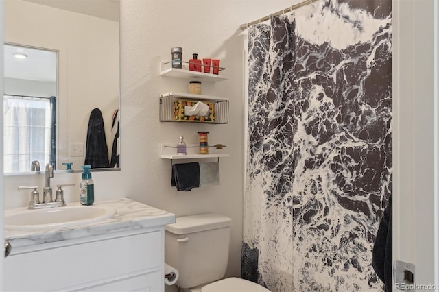 bathroom featuring vanity and toilet