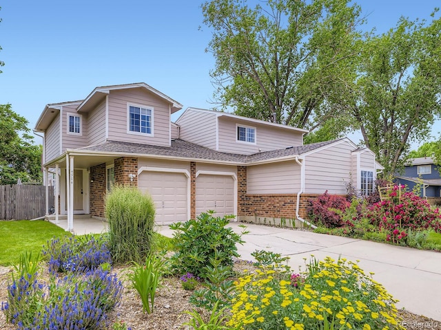 4904 E 125th Ave, Thornton, CO 80241 - view of front of house with brick siding, concrete driveway, a garage, and roof with shingles