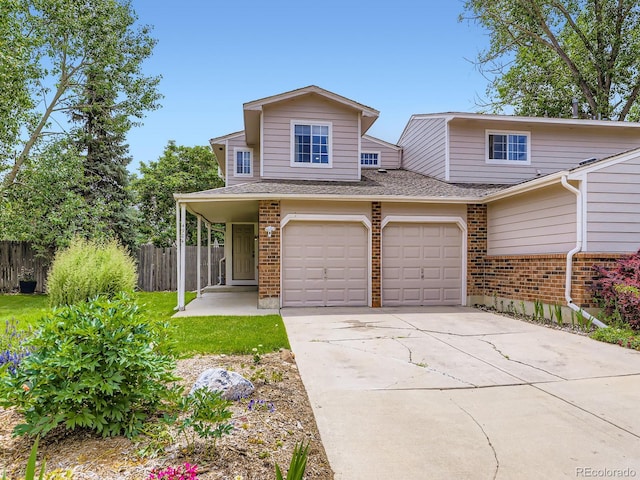 4904 E 125th Ave, Thornton, CO 80241 - view of front of house with brick siding, driveway, a shingled roof, and a garage