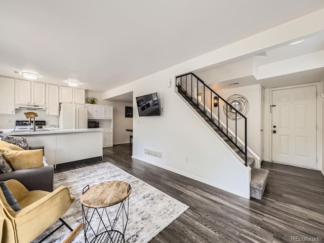 4904 E 125th Ave, Thornton, CO 80241 - living area featuring dark wood-style floors and stairs