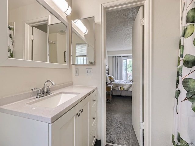 4904 E 125th Ave, Thornton, CO 80241 - ensuite bathroom featuring vanity and a textured ceiling