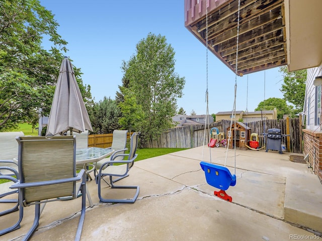 4904 E 125th Ave, Thornton, CO 80241 - fenced backyard with a patio, area for grilling, outdoor dining area, and a playground