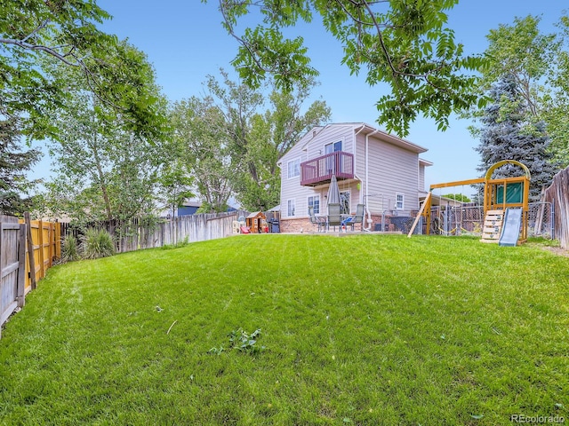 4904 E 125th Ave, Thornton, CO 80241 - back of house with a playground, a fenced backyard, and a balcony