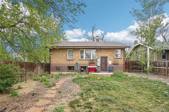 back of house featuring brick siding, a chimney, and a patio area