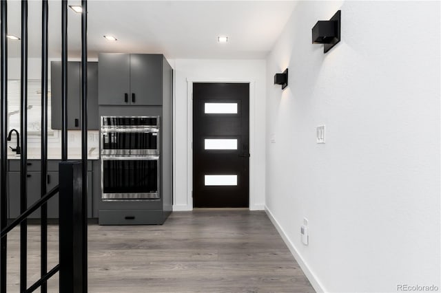 foyer entrance featuring dark wood-style floors and baseboards