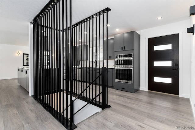 interior space featuring light wood finished floors, recessed lighting, and baseboards