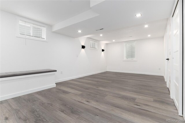 basement with baseboards, dark wood-style flooring, and recessed lighting