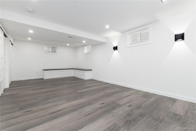 finished below grade area featuring dark wood-style floors, baseboards, and recessed lighting