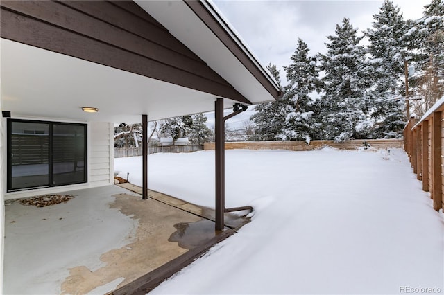 snow covered patio with fence