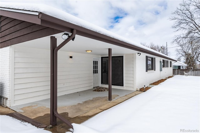 exterior space featuring brick siding and fence