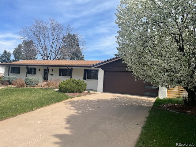 5886 S Logan St, Centennial, CO 80121 - single story home with a garage, a front lawn, brick siding, and driveway