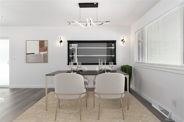 5886 S Logan St, Centennial, CO 80121 - dining room featuring baseboards, a chandelier, visible vents, and wood finished floors