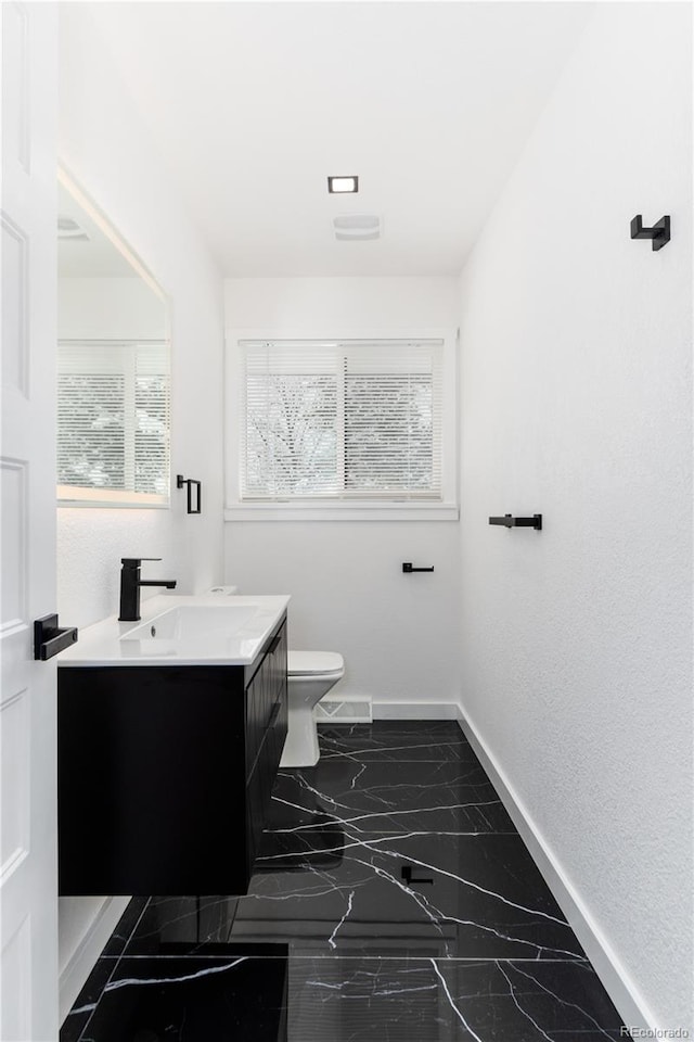 5886 S Logan St, Centennial, CO 80121 - bathroom featuring vanity, toilet, baseboards, and marble finish floor