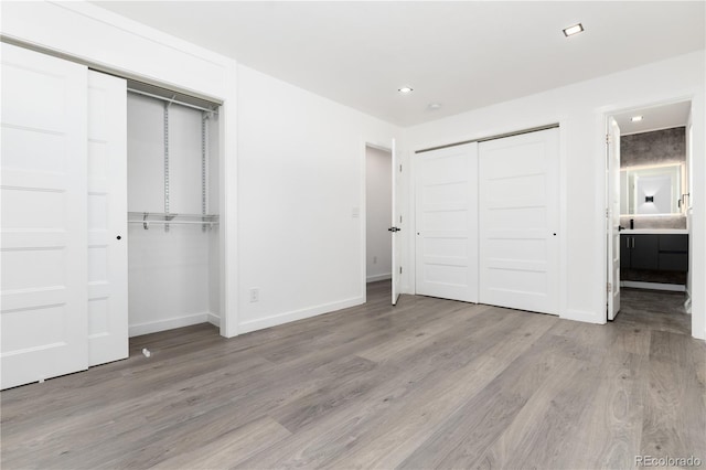 5886 S Logan St, Centennial, CO 80121 - unfurnished bedroom with baseboards, recessed lighting, multiple closets, and light wood-type flooring