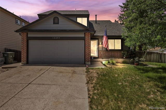 12099 Forest St, Thornton, CO 80241 - view of front of property featuring brick siding, driveway, a garage, and a shingled roof