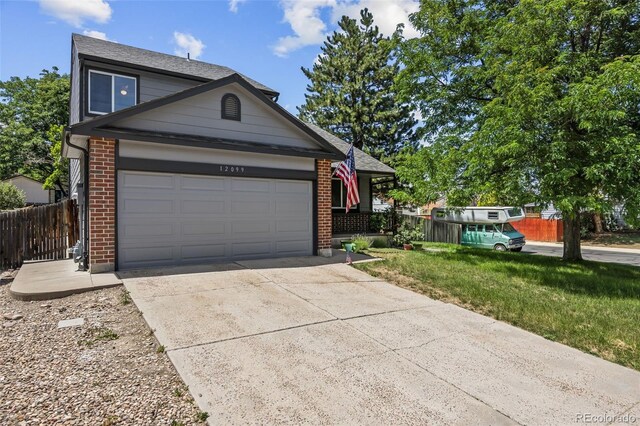12099 Forest St, Thornton, CO 80241 - view of front of home featuring brick siding, a garage, concrete driveway, and a shingled roof
