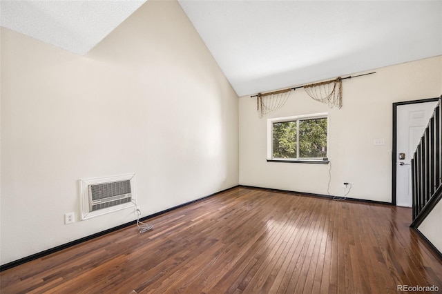 12099 Forest St, Thornton, CO 80241 - unfurnished room with wood-type flooring, lofted ceiling, stairs, and a wall mounted air conditioner