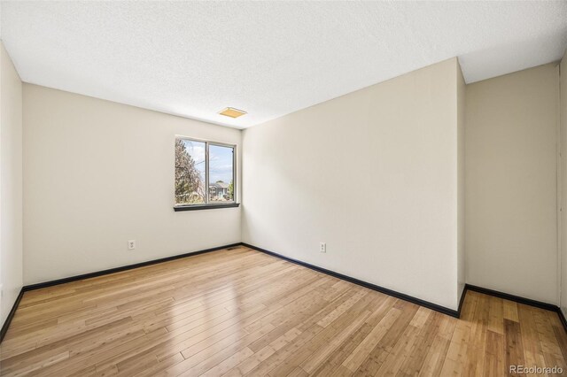 12099 Forest St, Thornton, CO 80241 - unfurnished room featuring wood finished floors and a textured ceiling