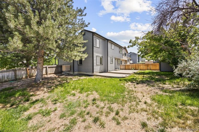 12099 Forest St, Thornton, CO 80241 - rear view of house with a fenced backyard and a patio area