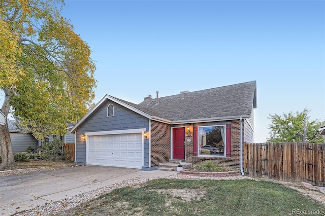 view of front of property featuring a front yard and a garage