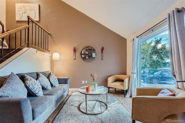 living room featuring hardwood / wood-style floors and lofted ceiling