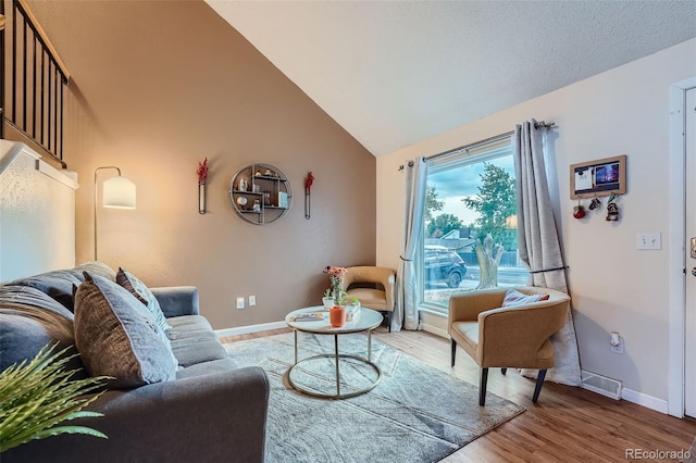 living room with lofted ceiling and hardwood / wood-style flooring