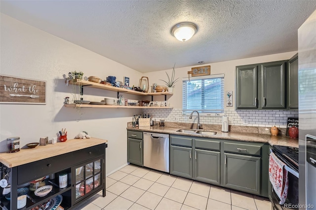 kitchen with stainless steel appliances, light tile patterned floors, a textured ceiling, decorative backsplash, and sink