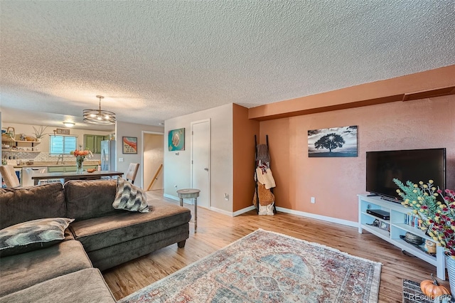 living room featuring wood-type flooring and a textured ceiling