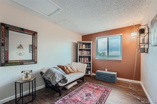 living area featuring a textured ceiling and hardwood / wood-style flooring