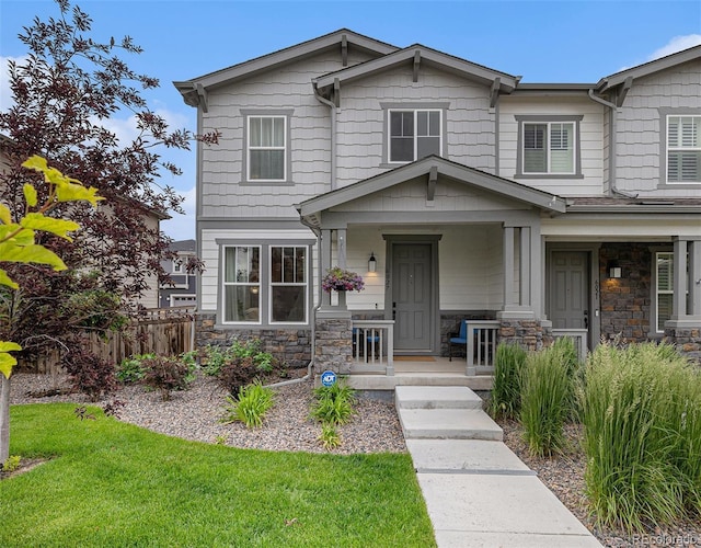6027 N Netherland Ct, Aurora, CO 80019 - craftsman house featuring a porch and stone siding