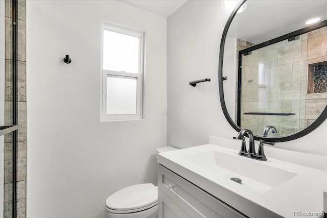 full bath with a shower stall, toilet, and vanity