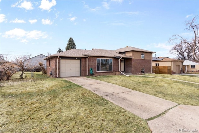 view of front of house featuring fence, concrete driveway, an attached garage, a front yard, and brick siding