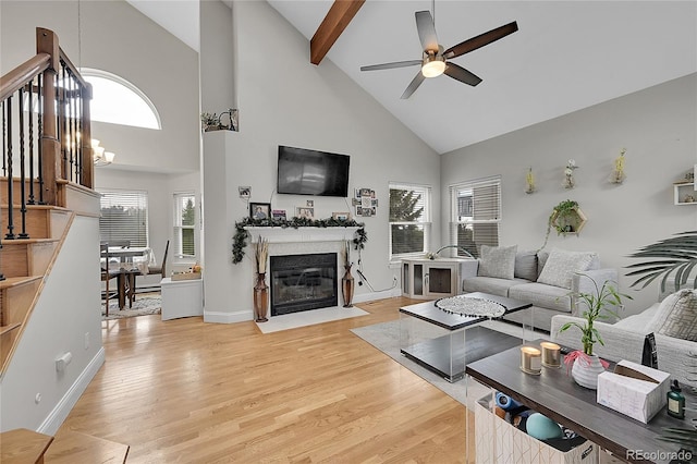3615 Birnamwood Dr, Colorado Springs, CO 80920 - living room with high vaulted ceiling, ceiling fan, light wood-style floors, a fireplace with flush hearth, and baseboards
