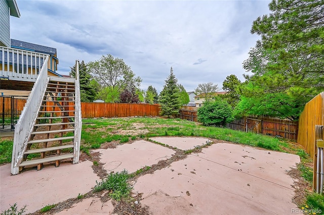 3615 Birnamwood Dr, Colorado Springs, CO 80920 - fenced backyard with stairway, a patio, and a wooden deck