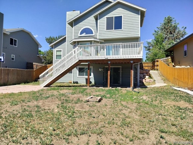 3615 Birnamwood Dr, Colorado Springs, CO 80920 - rear view of house featuring stairway, a deck, a fenced backyard, and a chimney