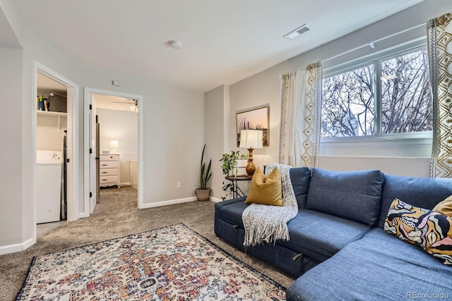 living area with washer / dryer, visible vents, baseboards, and carpet flooring