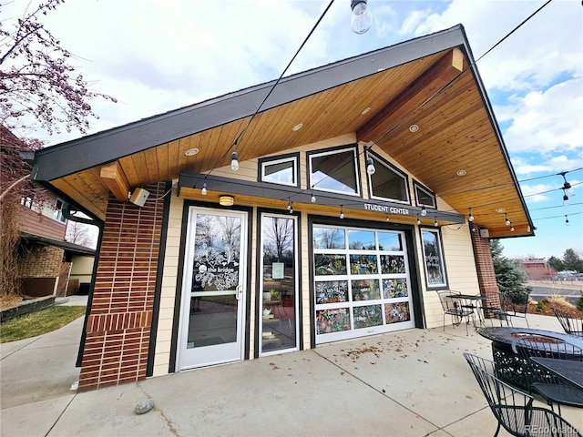 rear view of house with a patio area and brick siding