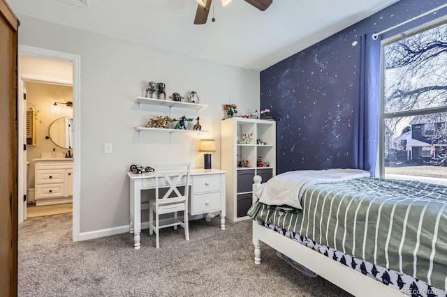 bedroom featuring wallpapered walls, baseboards, ceiling fan, an accent wall, and carpet floors