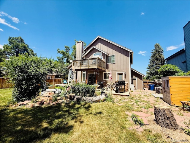 1744 Brookside Dr, Highlands Ranch, CO 80126 - back of house featuring a deck, a patio, a chimney, and board and batten siding