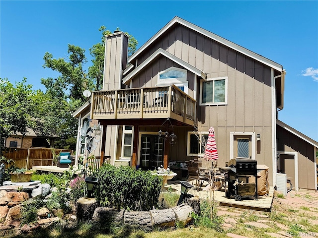 1744 Brookside Dr, Highlands Ranch, CO 80126 - rear view of property with board and batten siding, a chimney, and a patio area