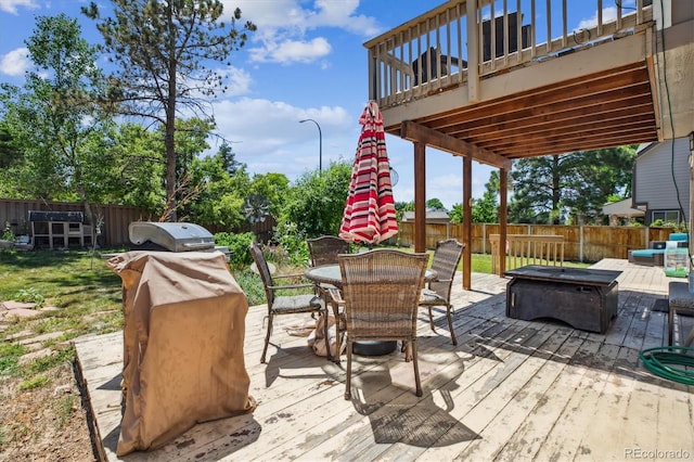 1744 Brookside Dr, Highlands Ranch, CO 80126 - wooden deck with outdoor dining space, an outdoor fire pit, and area for grilling